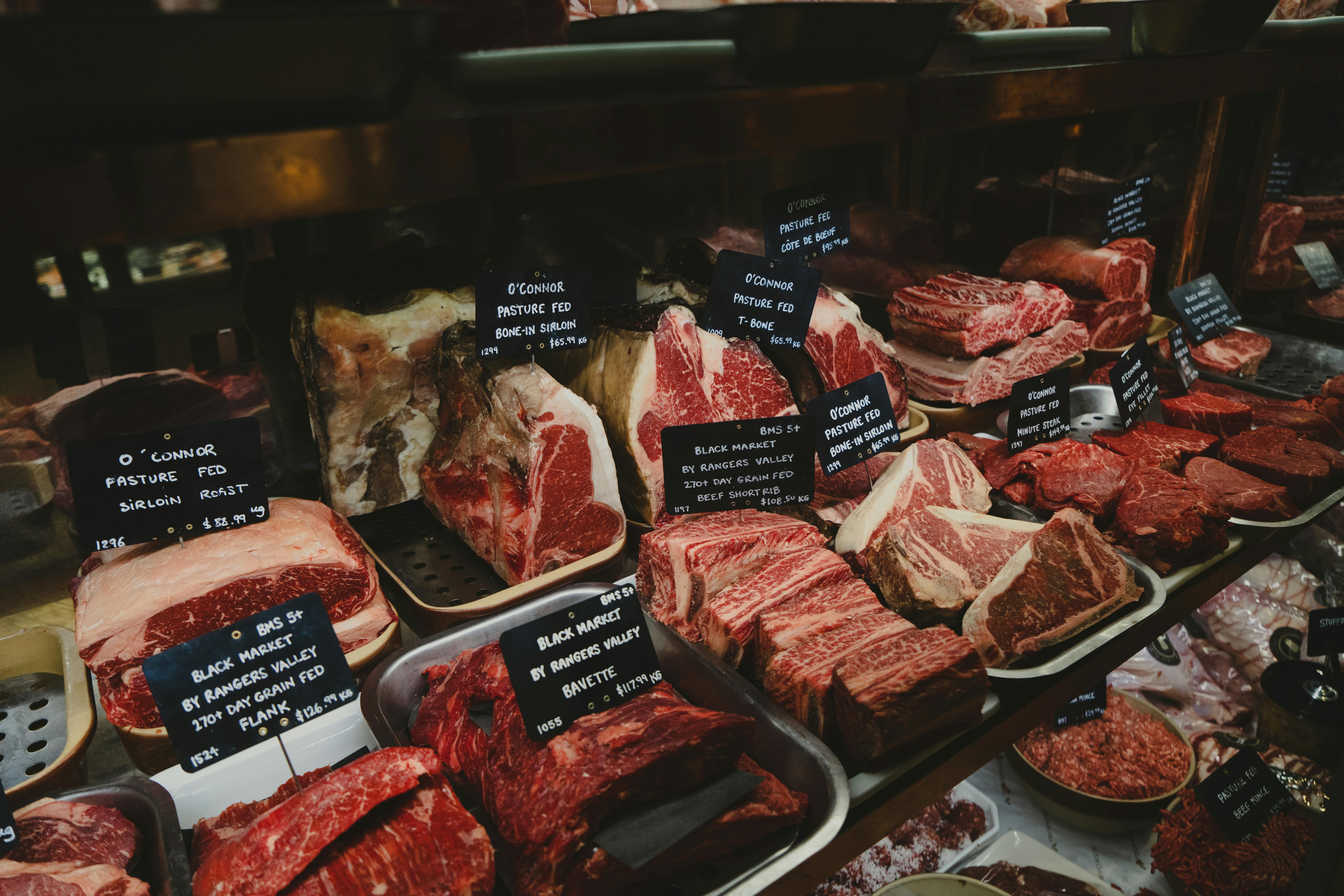 Counter hero — fresh lamb chops on butcher paper, overhead, natural light